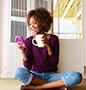 Woman drinking coffee looking at phone