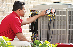 Service tech testing AC unit