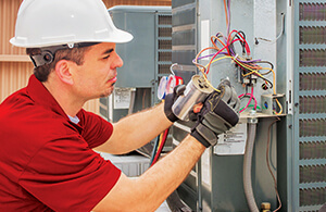 Leffler service tech working on AC unit