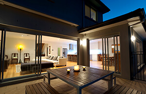 ai_generator10reasons2 View into living room at night from back porch