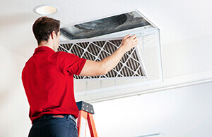 Leffler tech changing HVAC filter